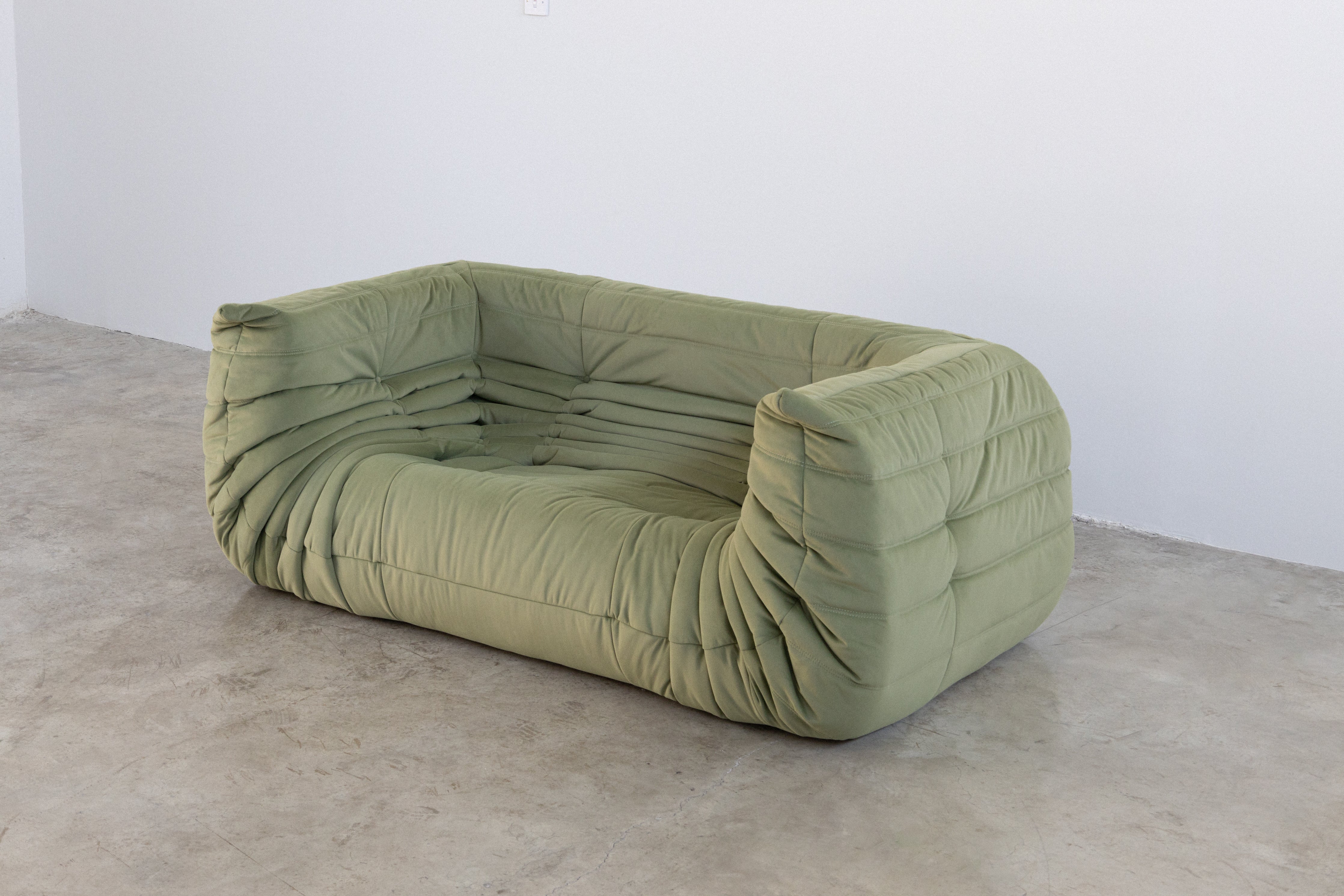 Light green modular sofa, 2-seater with a unique design.