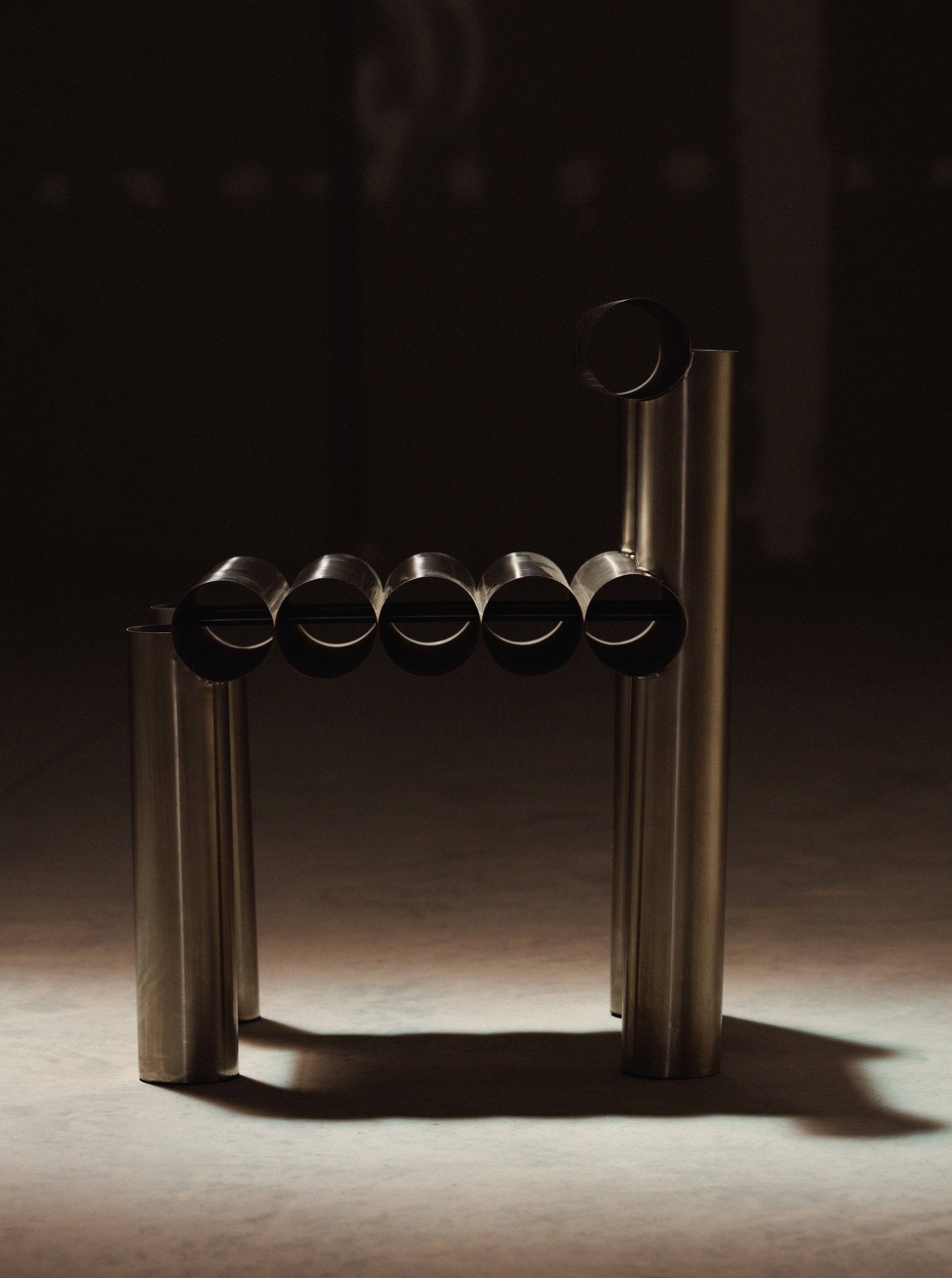 Metallic cylindrical object on a dark background