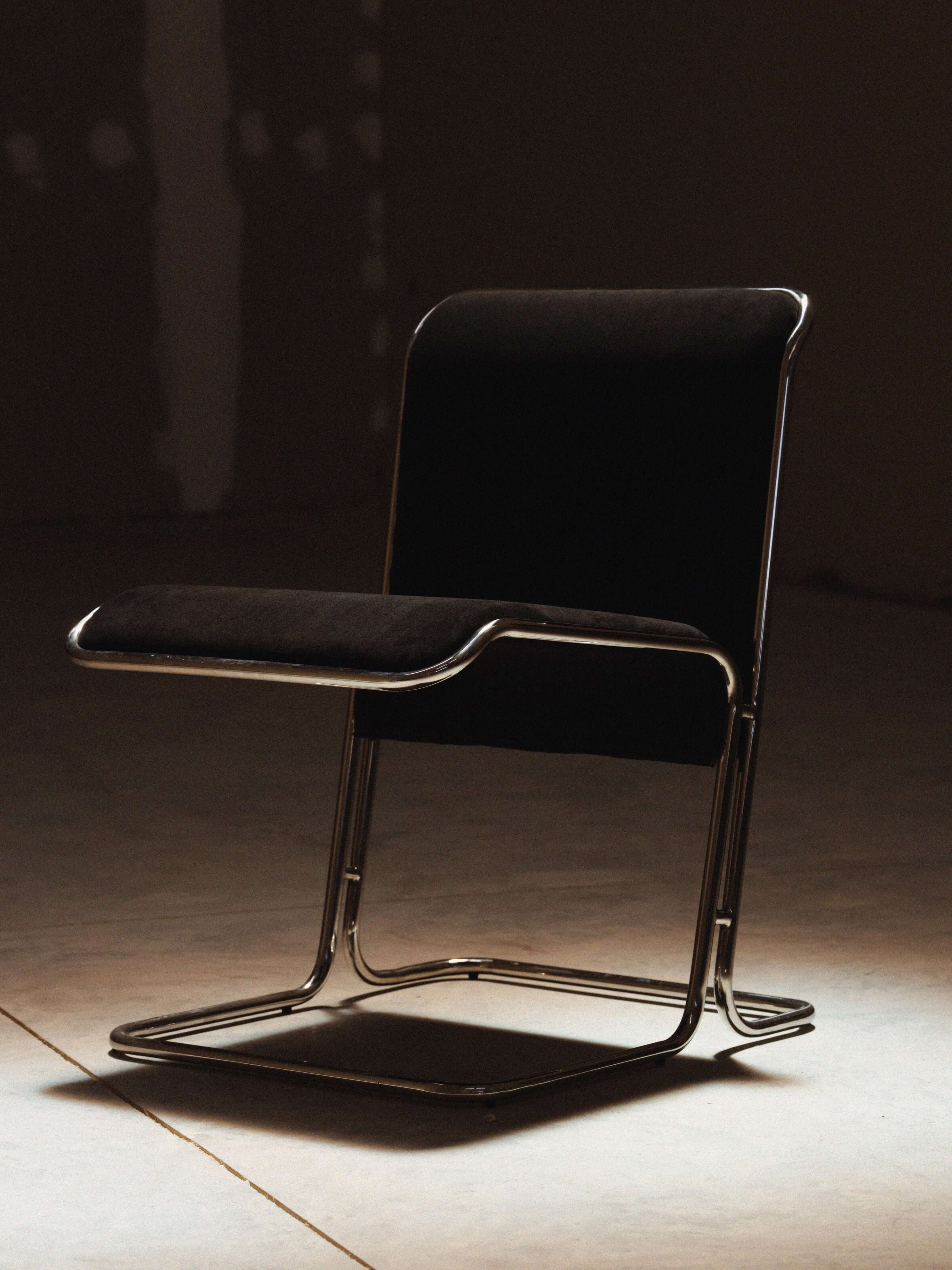 Calla Chair - Black chair with metal frame on a concrete floor