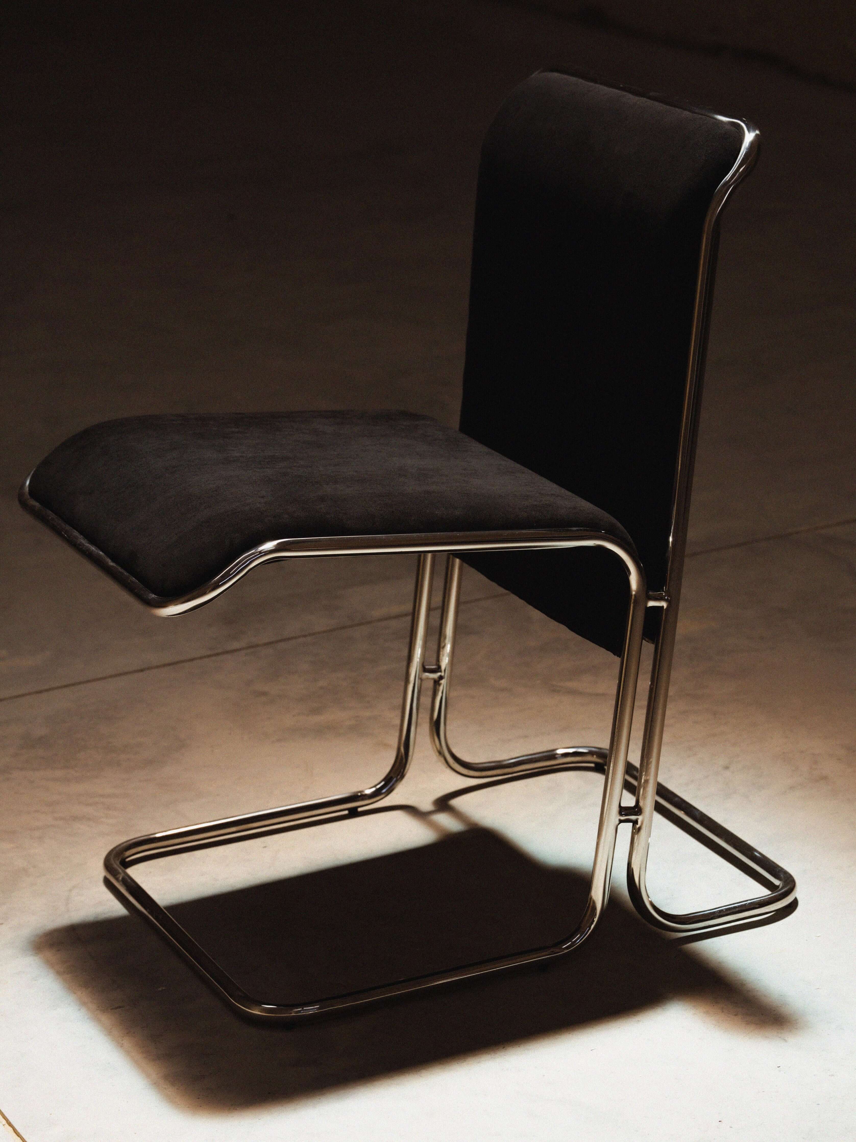 Calla Chair - Black chair with metal frame on a concrete floor