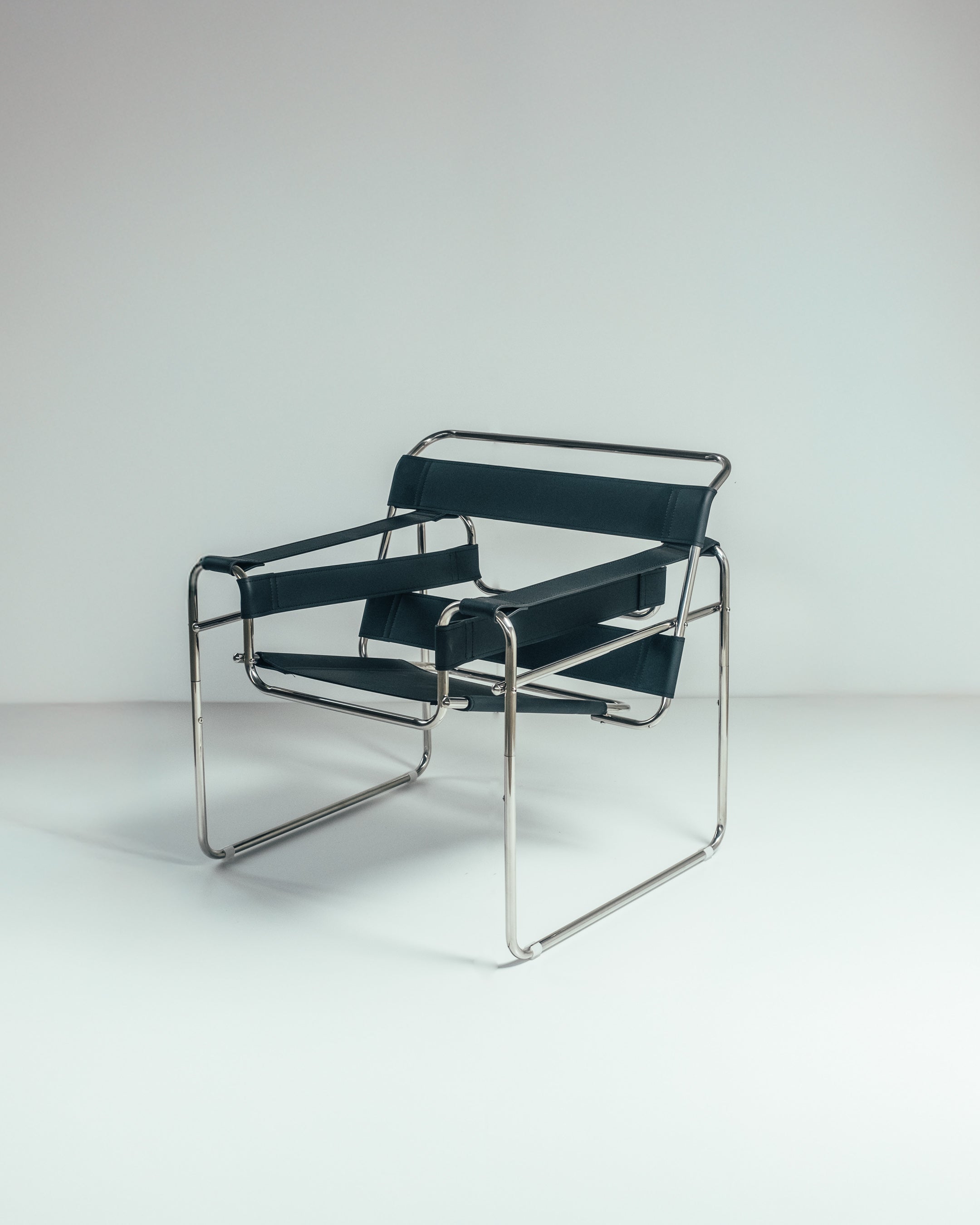 A Wassily chair with a chrome frame and brown leather seat, designed by Marcel Breuer.