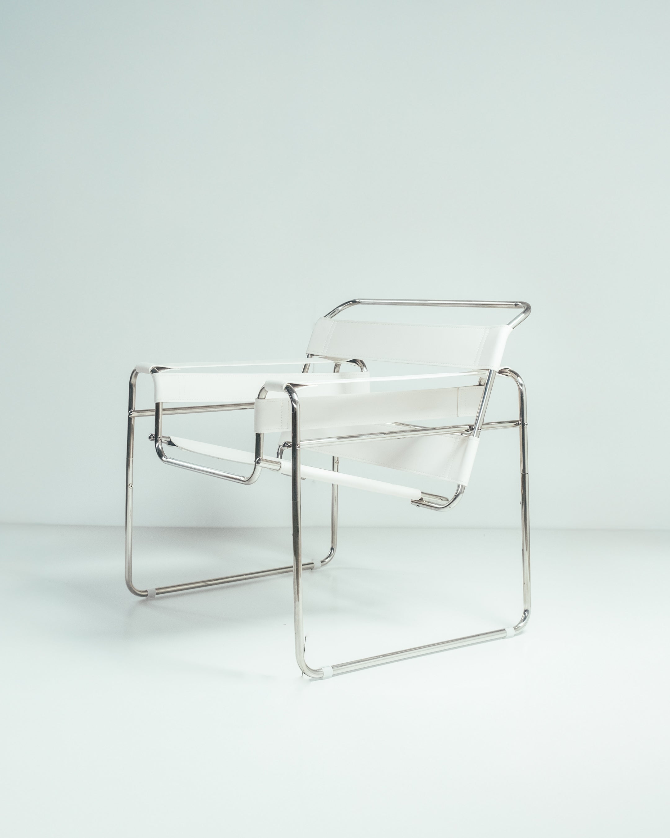 A Wassily chair with a chrome frame and brown leather seat, designed by Marcel Breuer.
