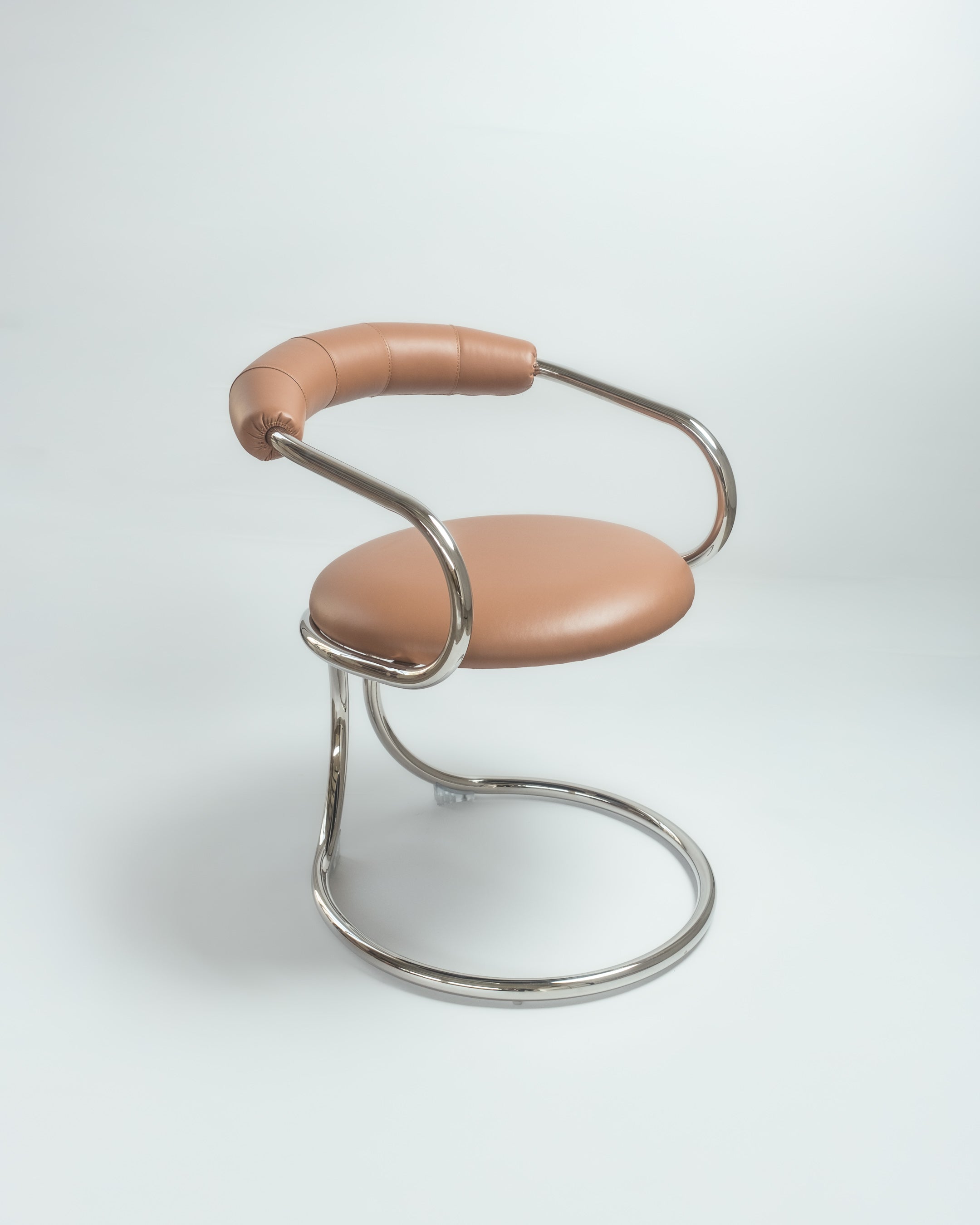 A black and silver metal chair with a unique design, featuring a circular seat and a handle.