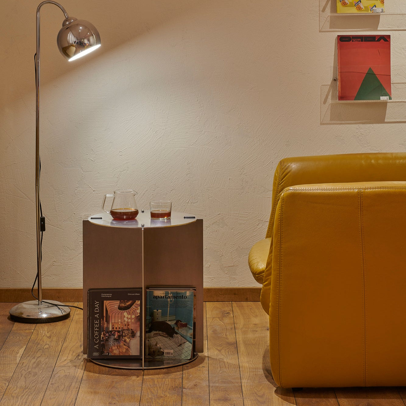 Modern interior with a yellow sofa, side table, and floor lamp.