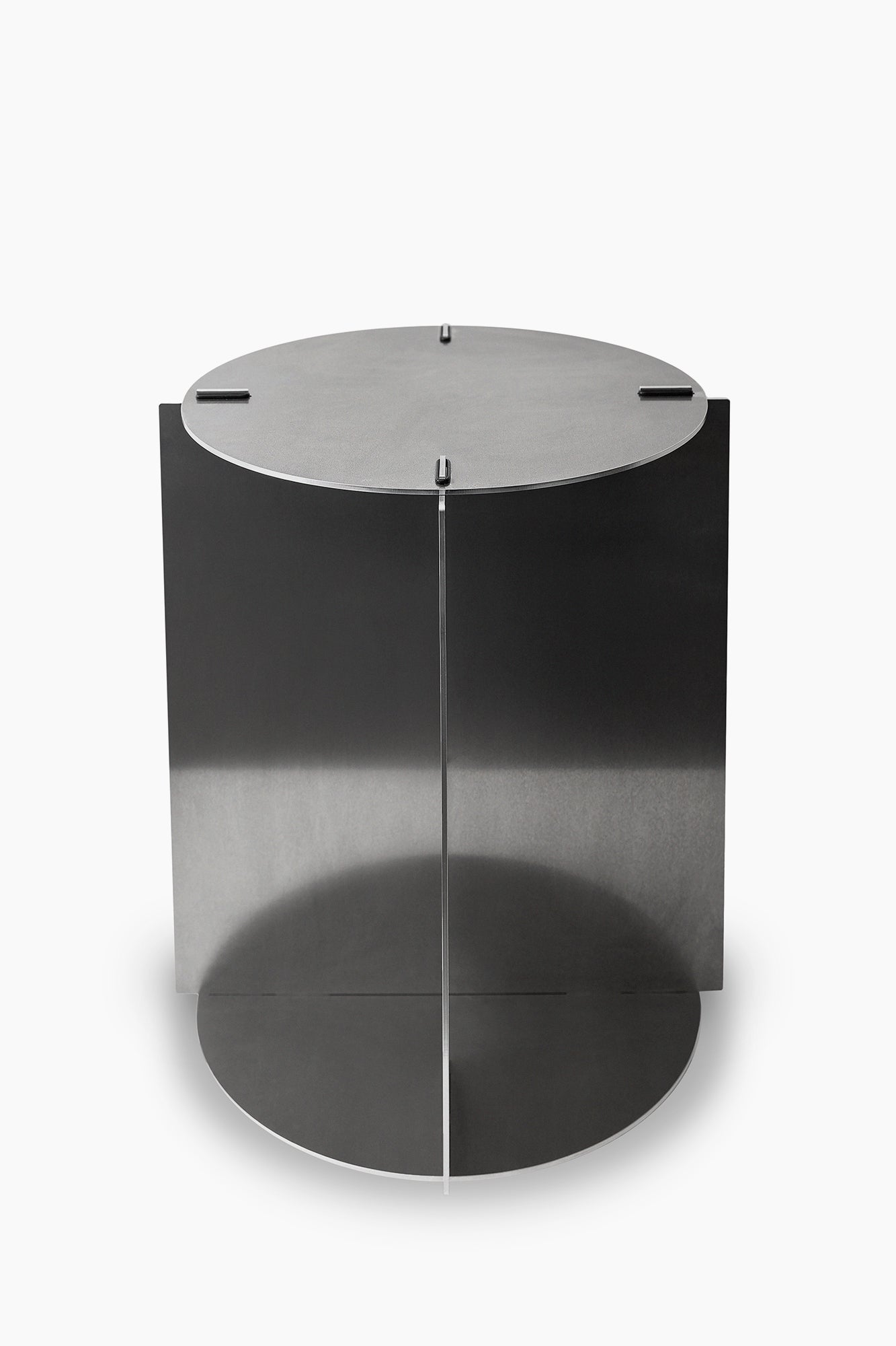 A cylindrical silver metal coffee table with a visible joint line.