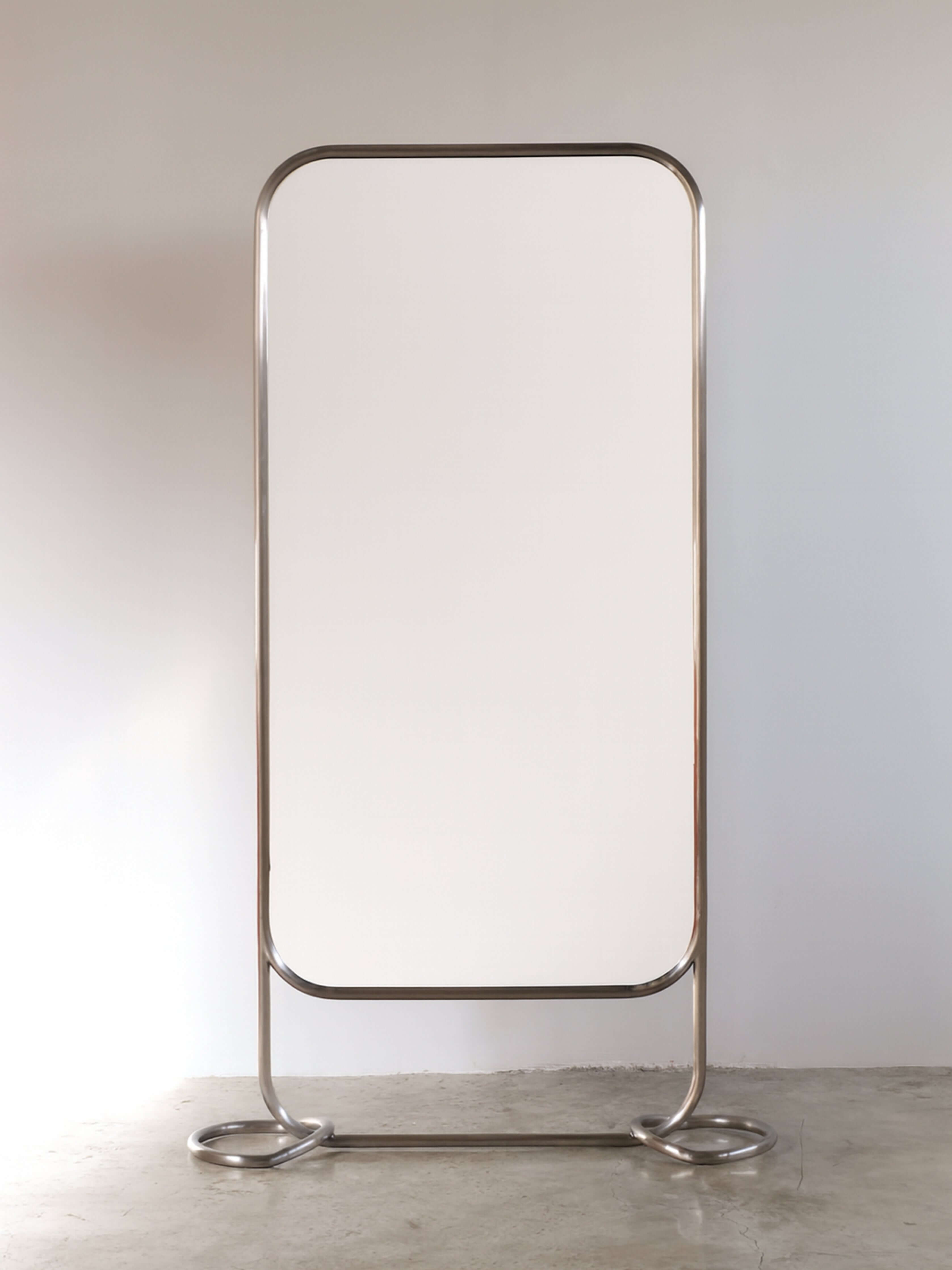 Contemporary stainless pipe mirror featuring a rounded rectangular frame and sleek brushed steel design.