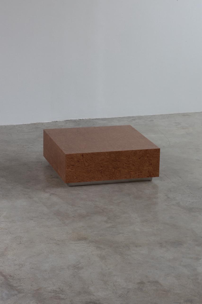 Brown rectangular brick on a gray surface with a white background