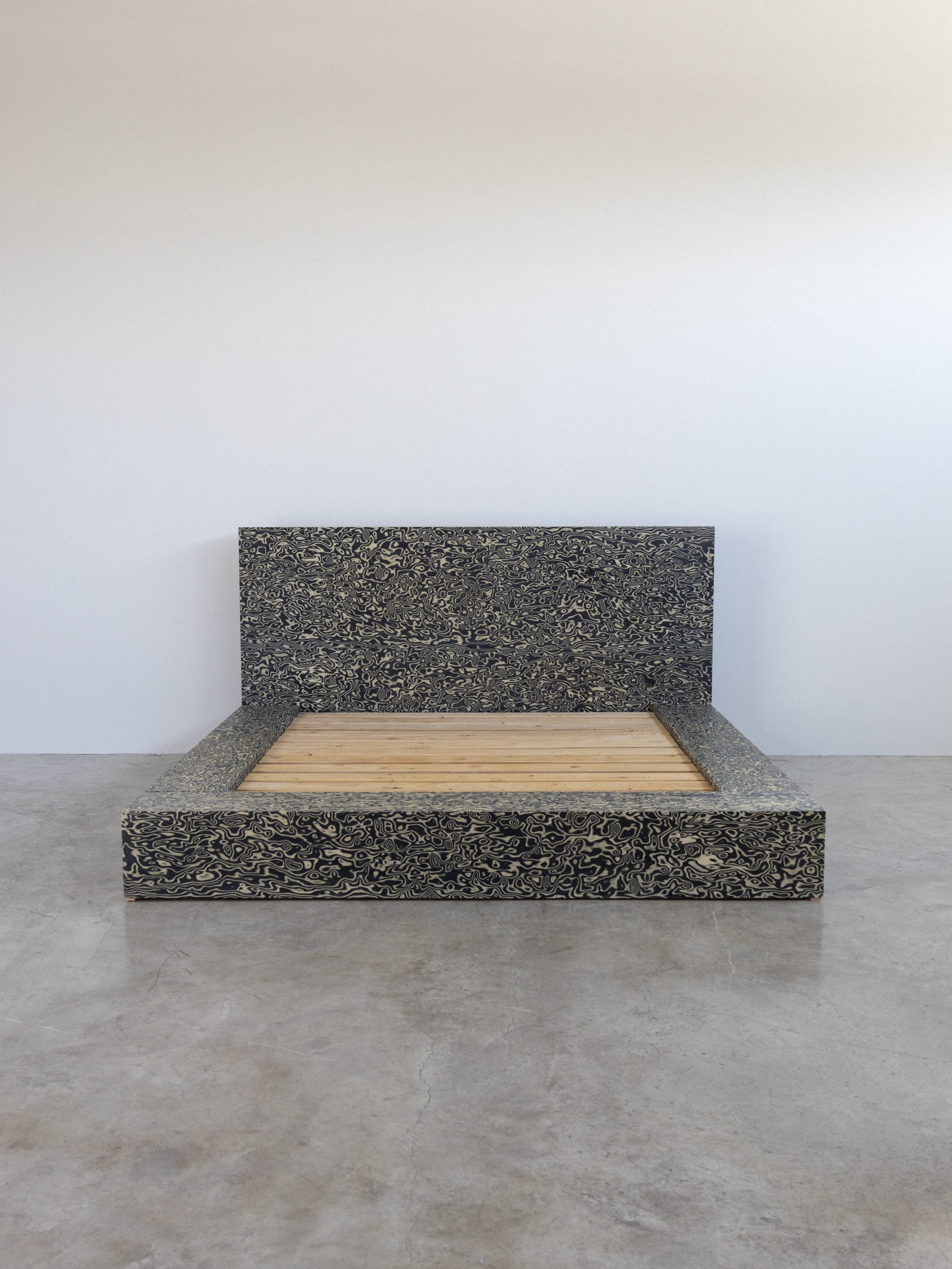 A bed frame made of veneer wood with a solid color, featuring a simple rectangular design.