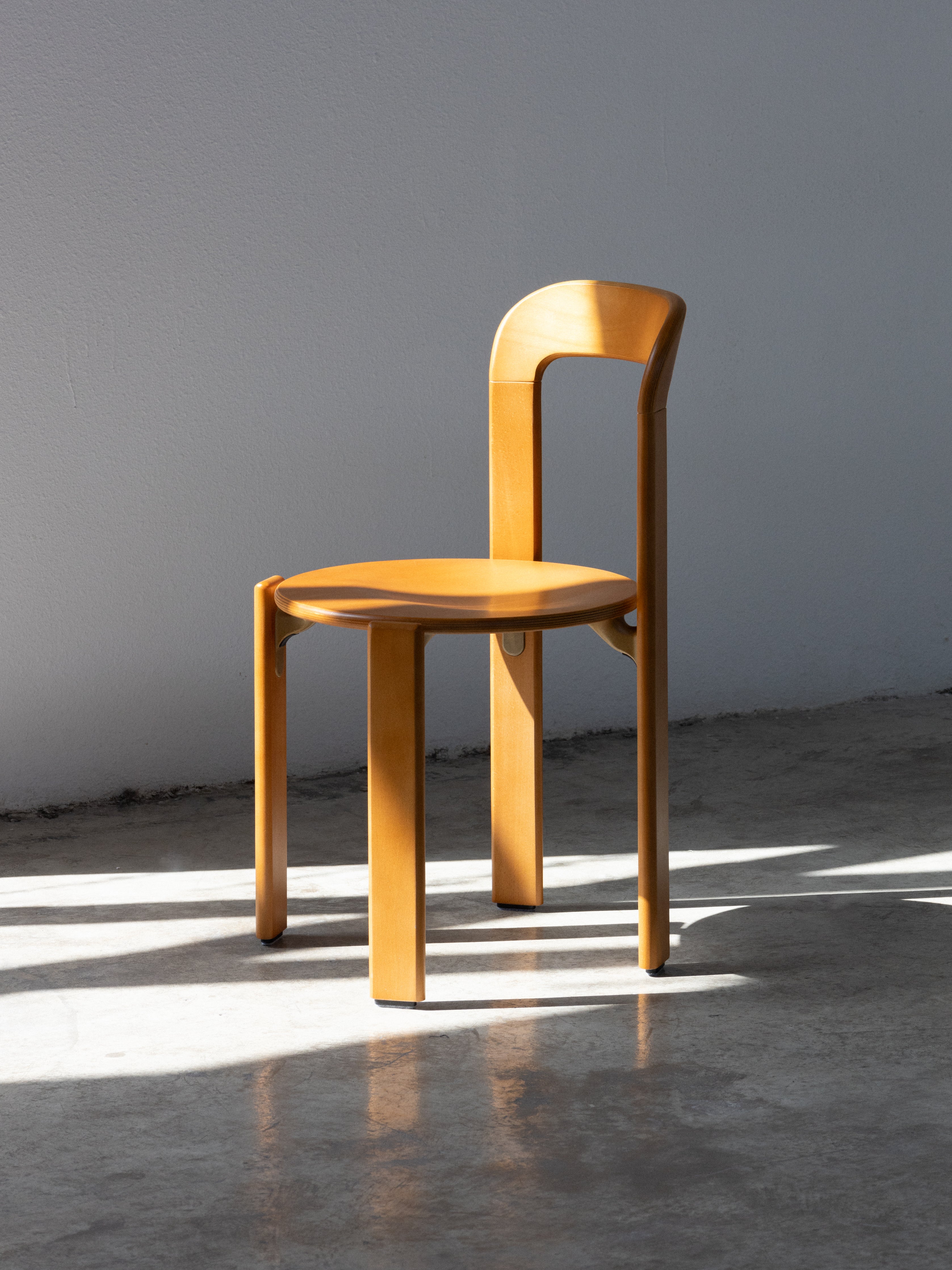 Wooden chair on a concrete floor with a gray background. rey chair