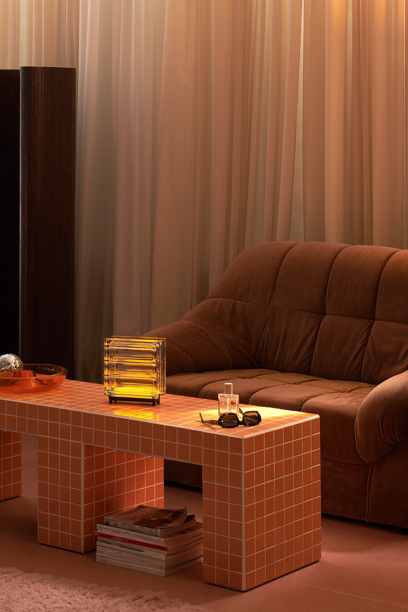 Brown sofa with a tiled coffee table in a living room setting