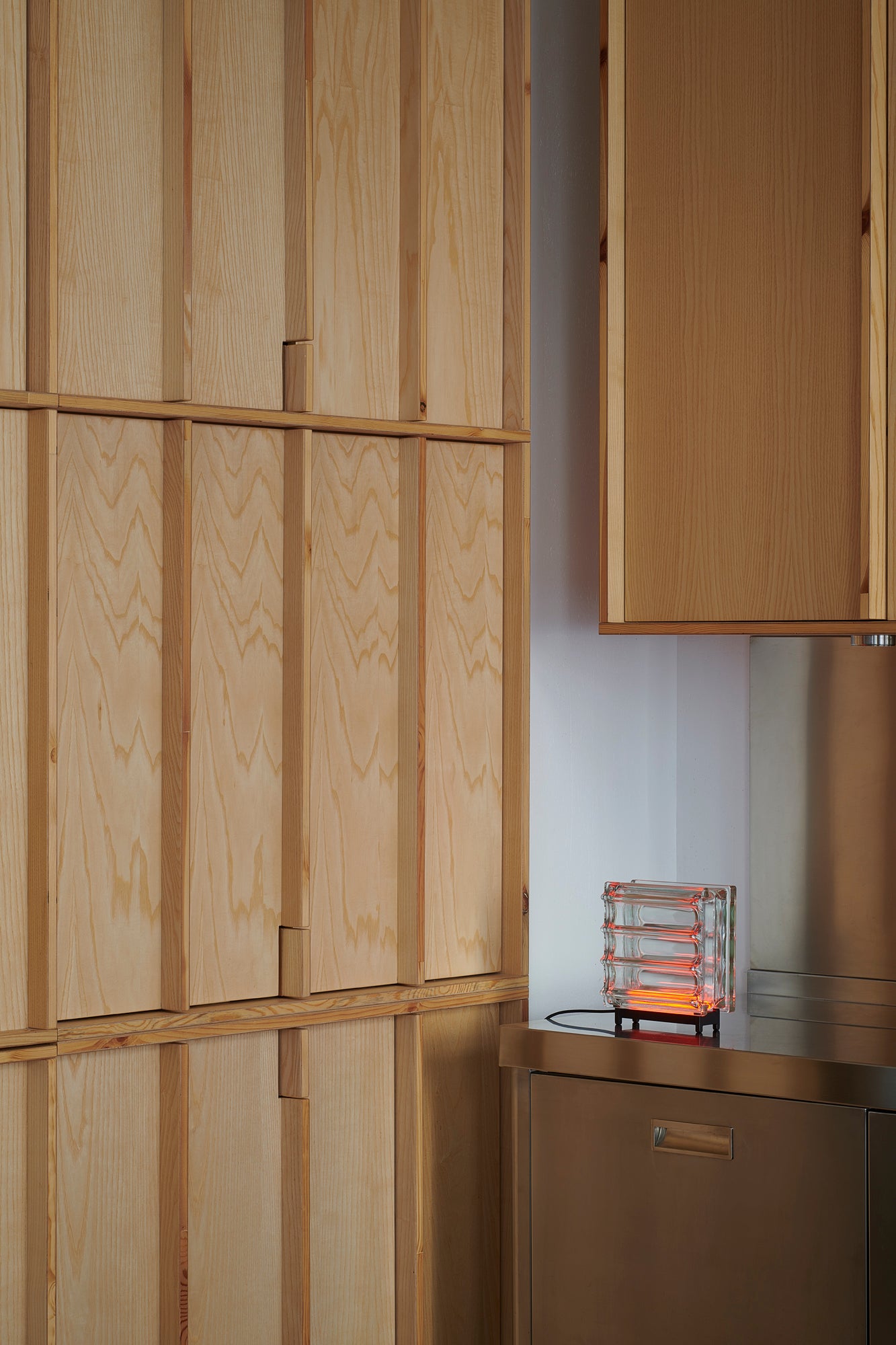 Wooden cabinets and a refrigerator in a kitchen setting