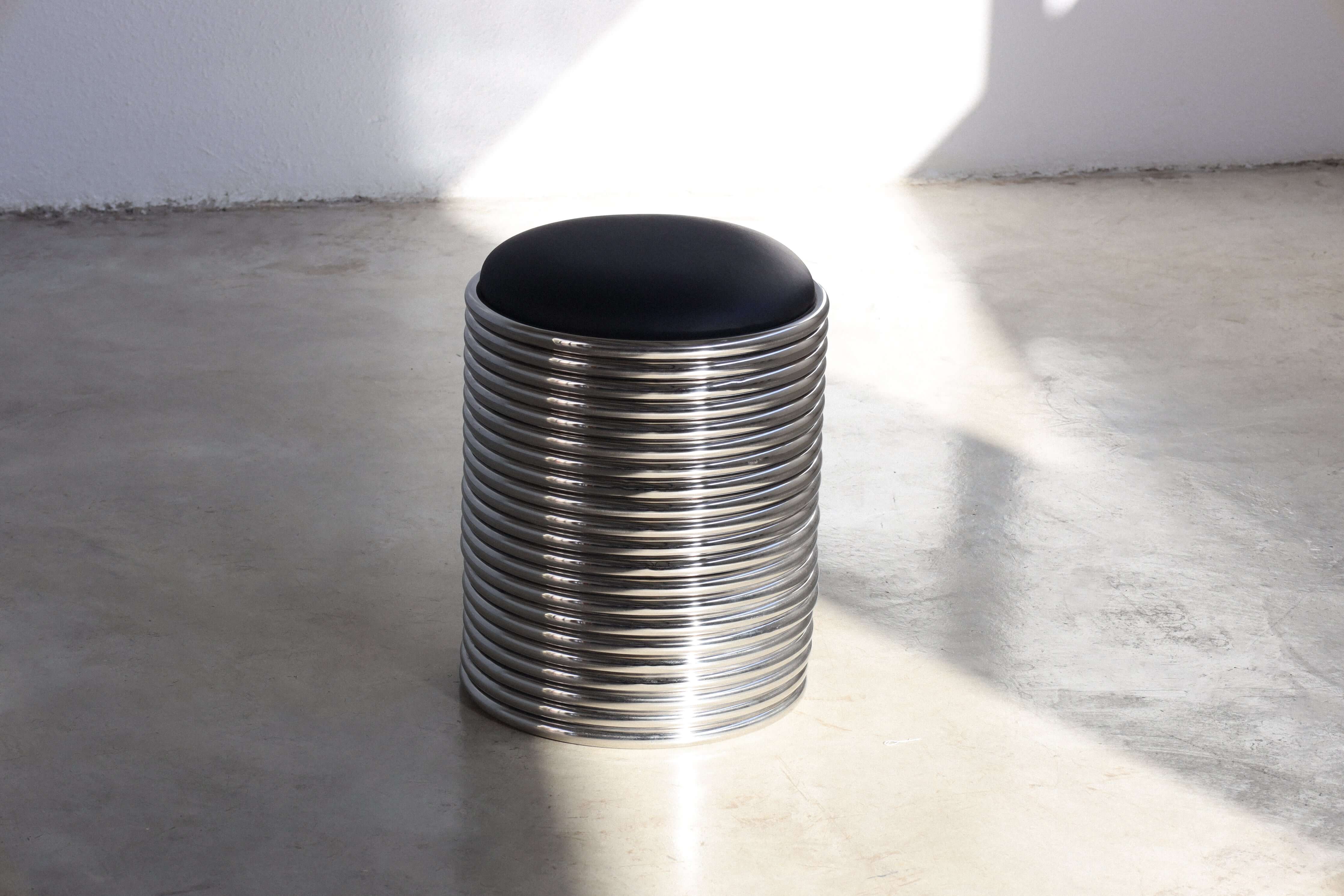 Rings Stool in black with a sleek metallic base, perfect for modern interiors and ready for delivery within 40 days.